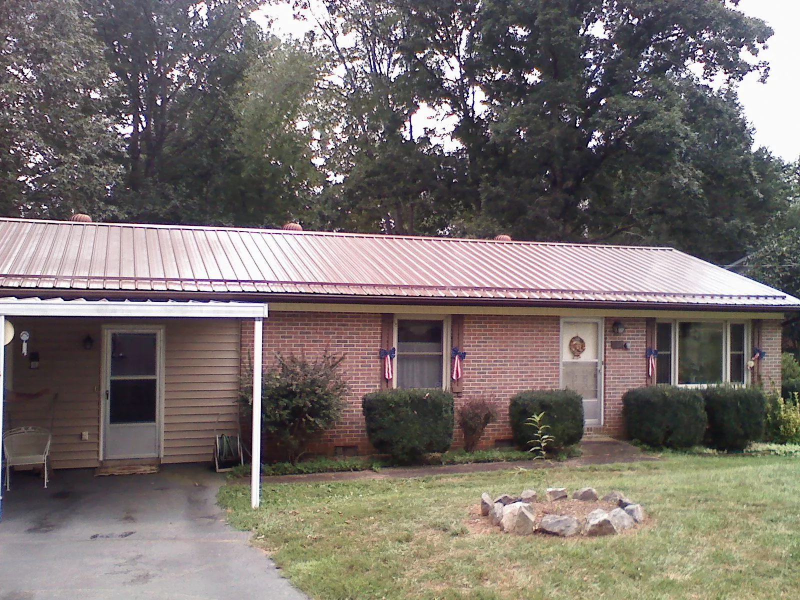 Bronze metal roof and carport on a brick ranch home — Roof Repair work by our crew in Minnesota City