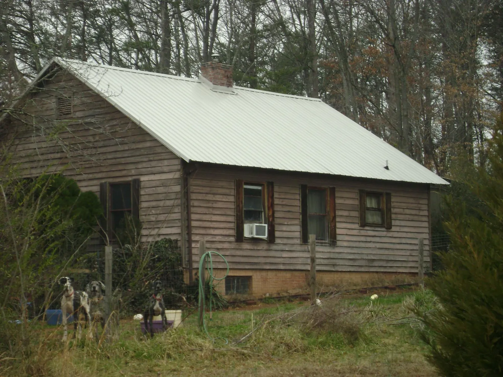 White metal roof on an old wood sided farmhouse, from a Metal Roof Installation job in Minnesota City